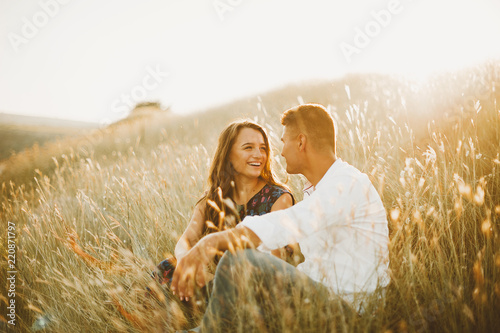 Happy in love couple having fun outdoor in nature at sunset, smiling girl, engagement