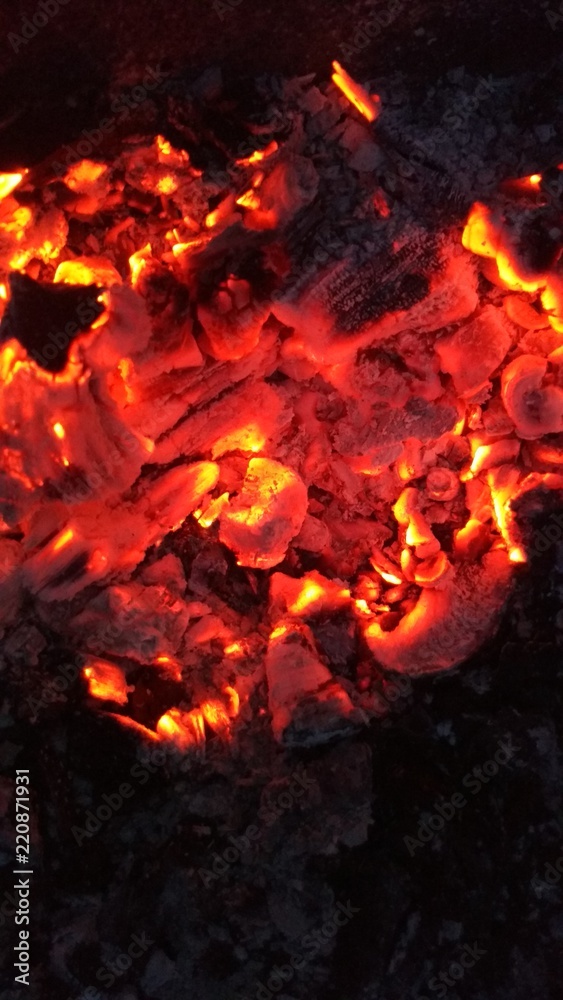 Still not cooled coals after the morning bonfire Still not cooled coals after the morning bonfire