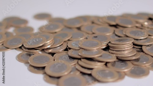 Some real 1 coins spread out and lined up on the table