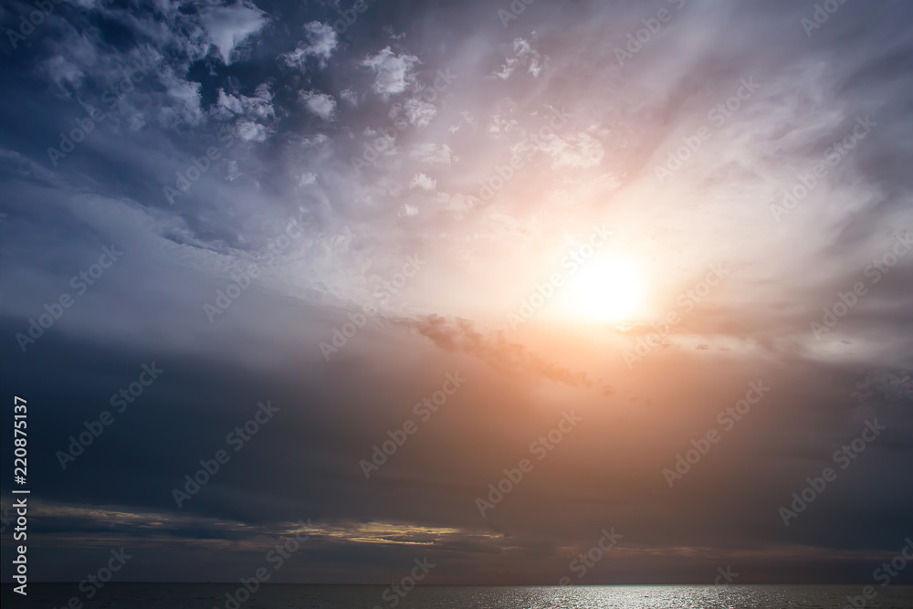 sunset in the cloudy sky over the sea