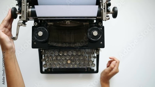 High angle view of woman hands insert paper into typewriter