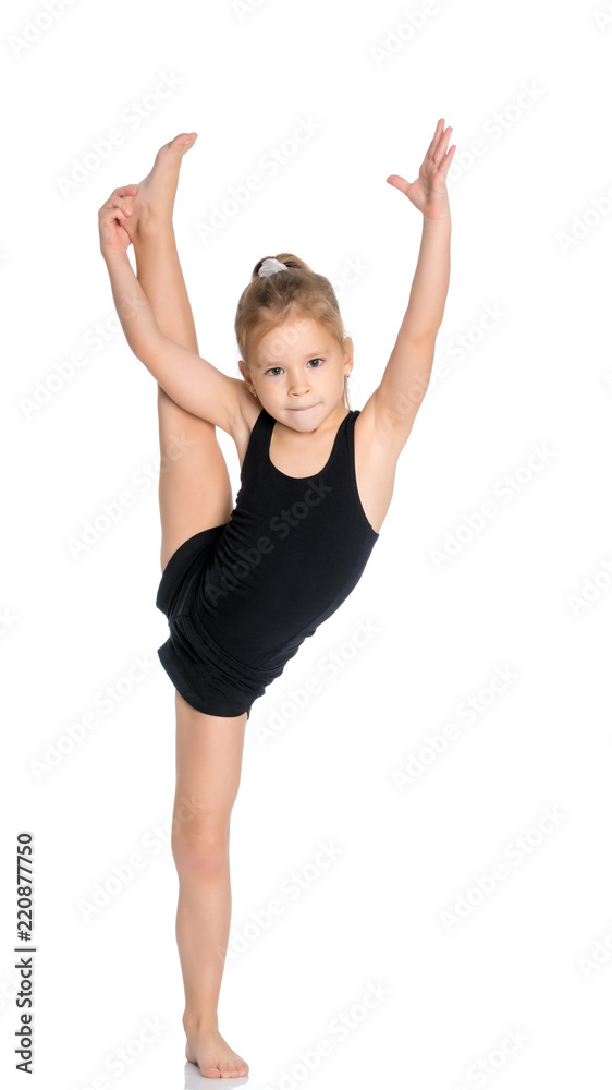 The gymnast balances on one leg. The gymnast balances on one leg.