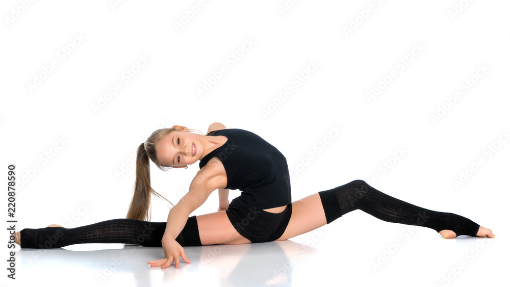 Girl gymnast perform the twine exercise. Girl gymnast perform the twine exercise.