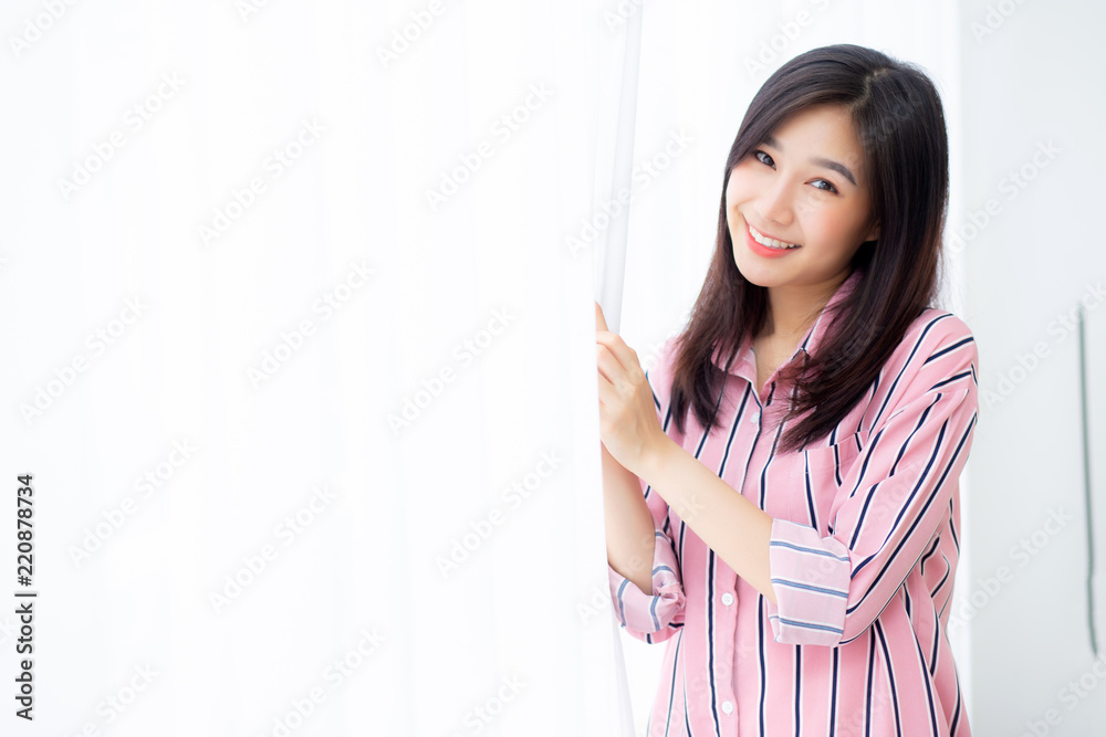Portrait of beautiful young asian woman standing the window and smile while wake up with sunrise at morning, lifestyle and relax concept. Portrait of beautiful young asian woman standing the window and smile while wake up with sunrise at morning, lifestyle and relax concept.