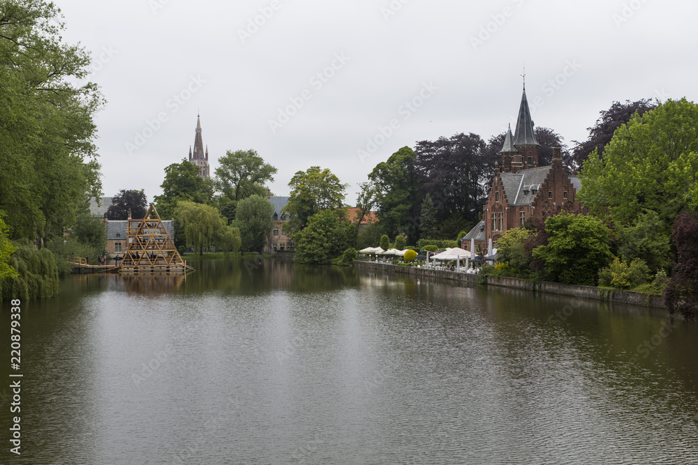 Minnewater castle at the Lake of Love in Bruges, Belgium