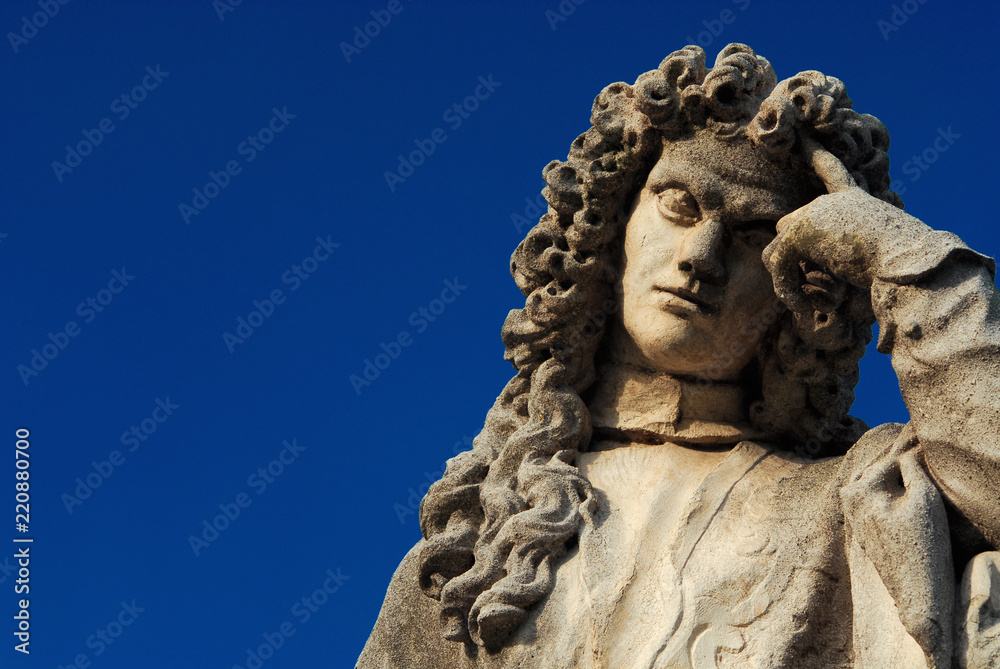 Man statue in the act of thinking against blue sky. Bernardo Nani monument erected in the 18th century in Padua, great venetian scholar (with copy space)