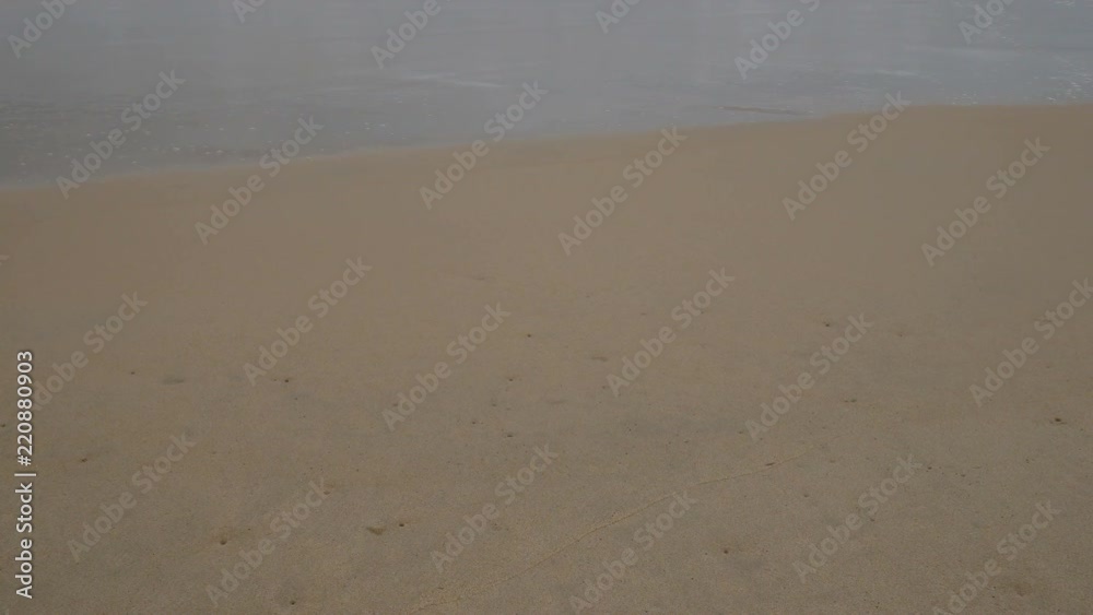 Beautiful sand beach with soft wave in sea water , cloudy rainy sky day Beautiful sand beach with soft wave in sea water , cloudy rainy sky day