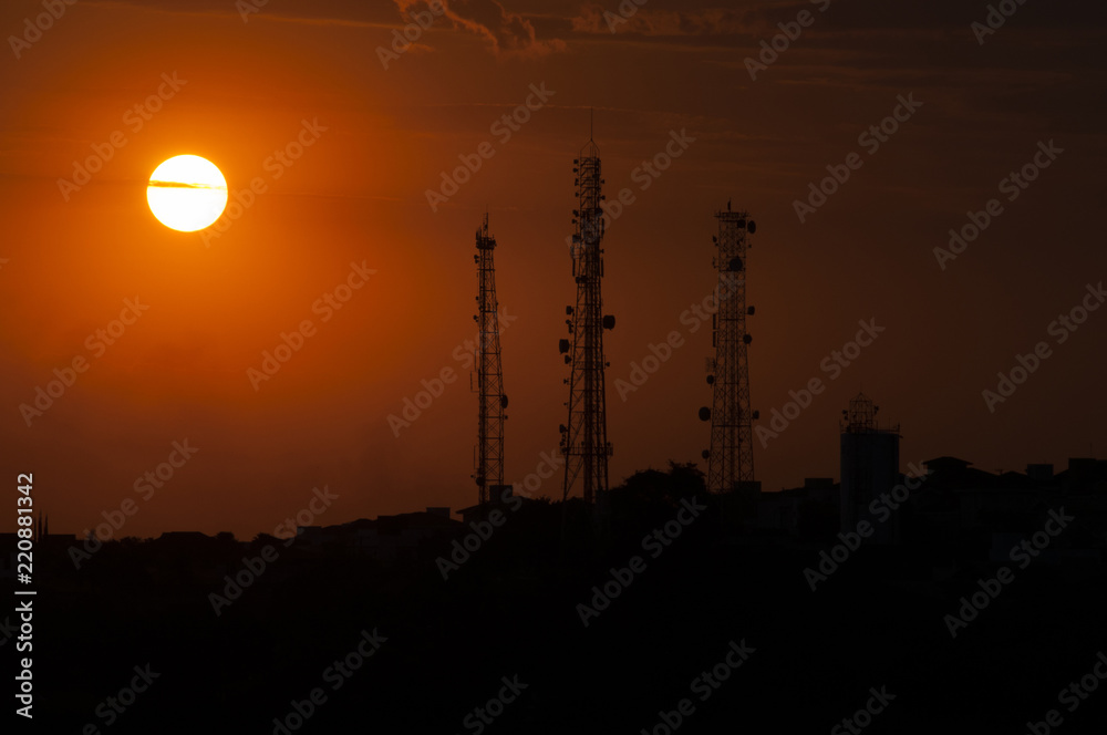 Naklejka premium communication towers in the sunset