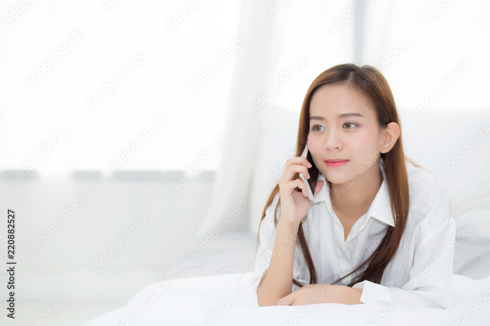 Beautiful young asian woman smiling lying and relax on the bed in the morning, girl using mobile smart phone talking enjoy, communication concept. Beautiful young asian woman smiling lying and relax on the bed in the morning, girl using mobile smart phone talking enjoy, communication concept.