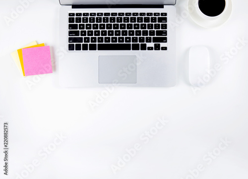 Top view of laptop computer and mouse, diary and notepad for reminder and a cup of coffee isolated on white background, notebook and supplies on desk office, business and workplace concept.
