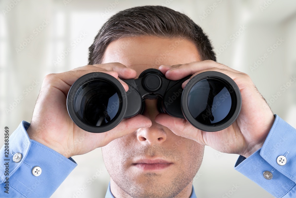 Young handsome man in shirt with binoculars Young handsome man in shirt with binoculars