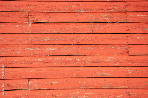 Aging boards on the side of an old red barn