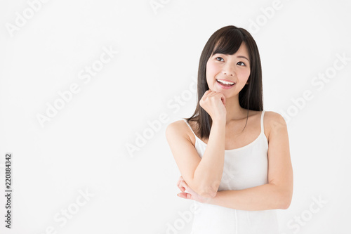 attractive asian woman thinking on white background