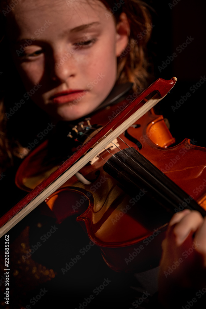 close up of violin with blurred girl playing it close up of violin with blurred girl playing it