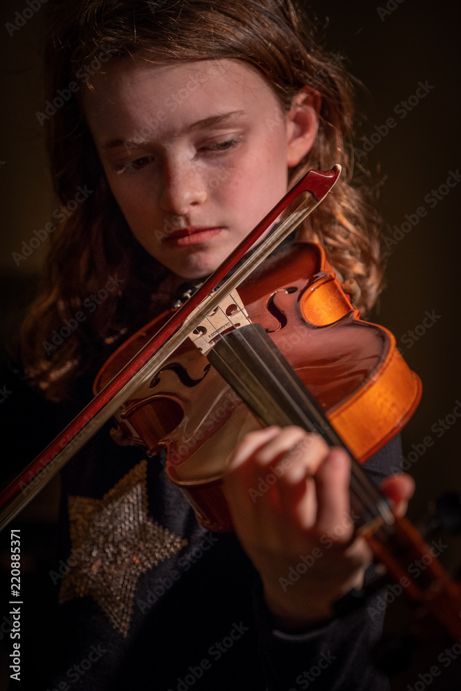 girl concentrating on playing violin girl concentrating on playing violin