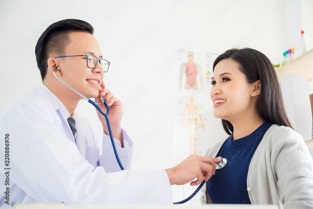 Doctor checking female patient's heartbeat by stethoscope at hospital Stock  Photo | Adobe Stock