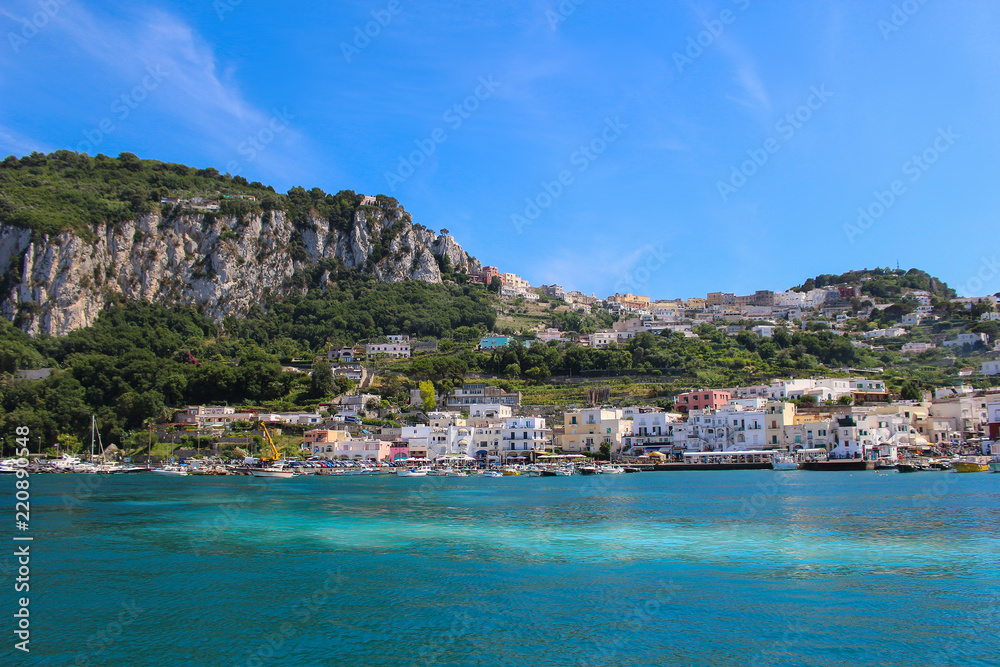 Beautiful island of Capri with clear blue waters and busy shore