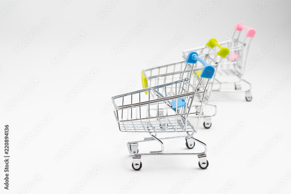 Close up of supermarket grocery push cart for shopping with black wheels on white background. Concept of shopping. Close up of supermarket grocery push cart for shopping with black wheels on white background. Concept of shopping.