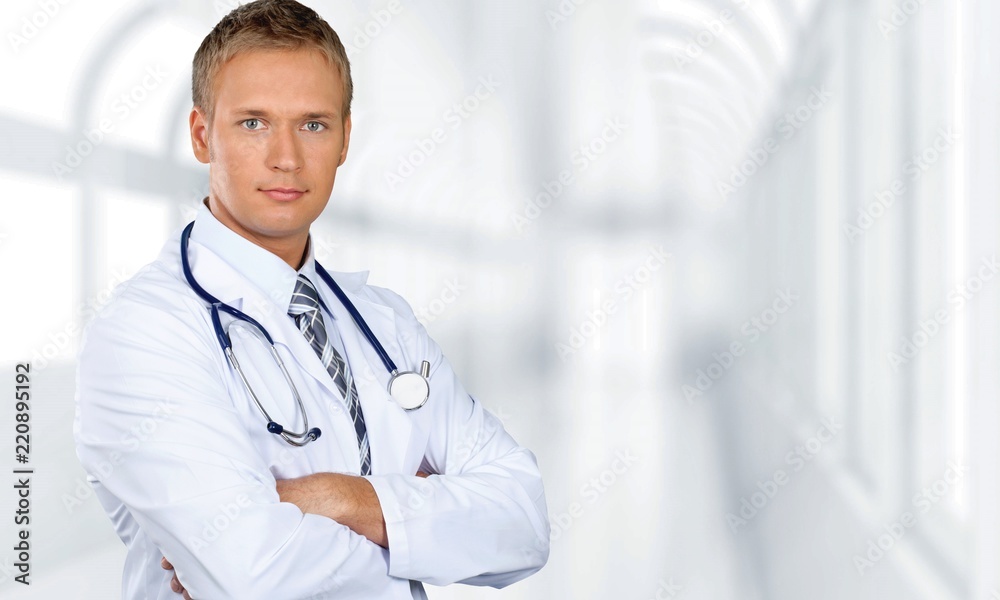 Handsome male doctor with stethoscope on neck on background