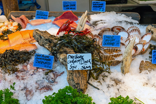 Fish, seafood and scallops for sale at a market in London, UK photo