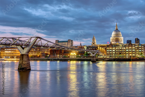 St. Paul's cathedral and the Millennium Bridge in London, UK, after sunset