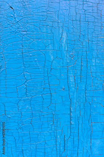 weathered wooden planks background with cracked blue paint texture 