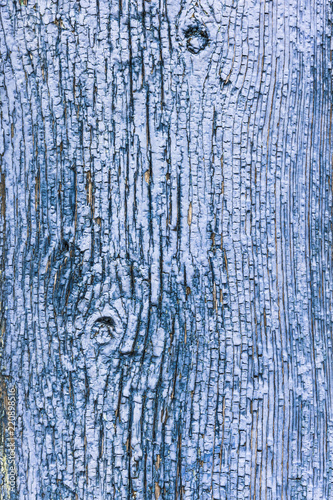 old wooden blue painted surface with faded and cracked paint