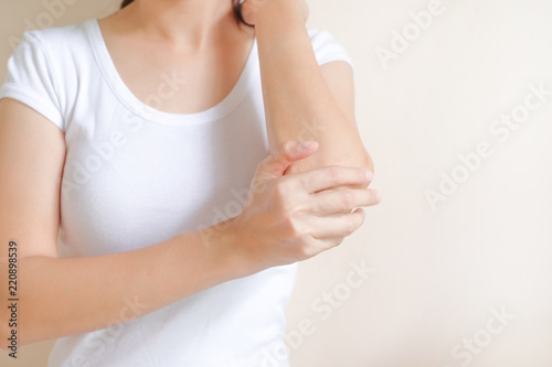 Woman suffering from arm pain on white background, Healthcare concept.