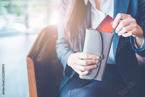 Women's hand Using a credit card, she pulled the card out of her wallet.