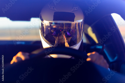 A Helmeted Driver At The Wheel Of His Race Car © SIX60SIX