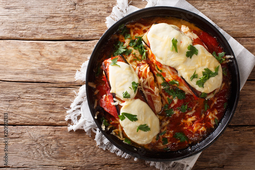 Italian chicken Sorrentino baked with eggplant, prosciutto, cheese and marinara sauce close-up. Horizontal top view