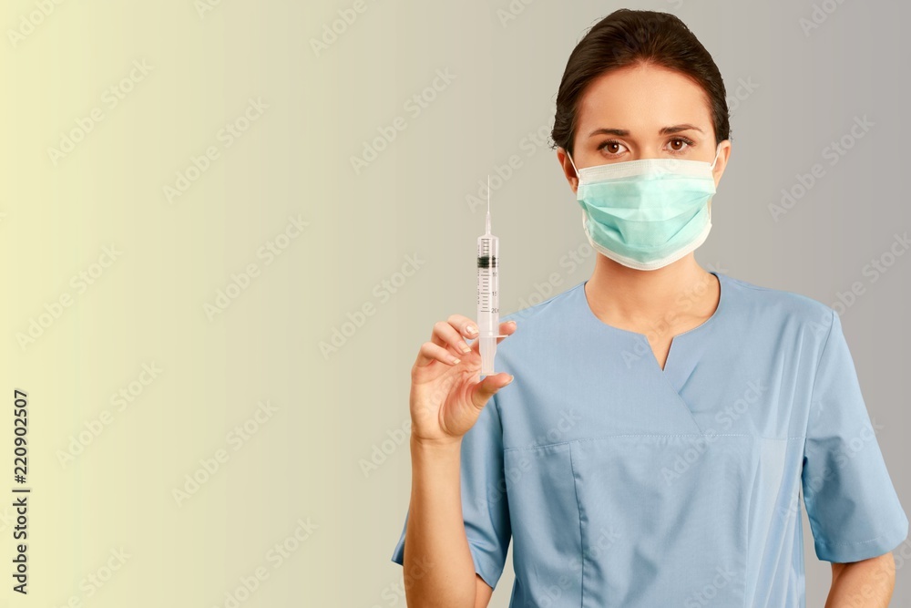 Attractive young female doctor with syringe Attractive young female doctor with syringe