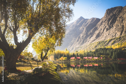 Autumn scene of morning in lower Kachura lake with mountains in the background and reflection in still water. Shangrila Skardu. Gilgit-Baltistan, Pakistan. photo