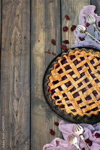 Traditional American cherry pie on a dark wooden background