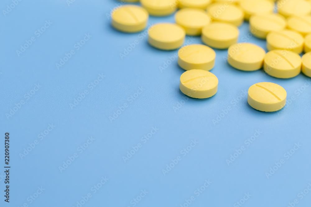 yellow pills on blue background