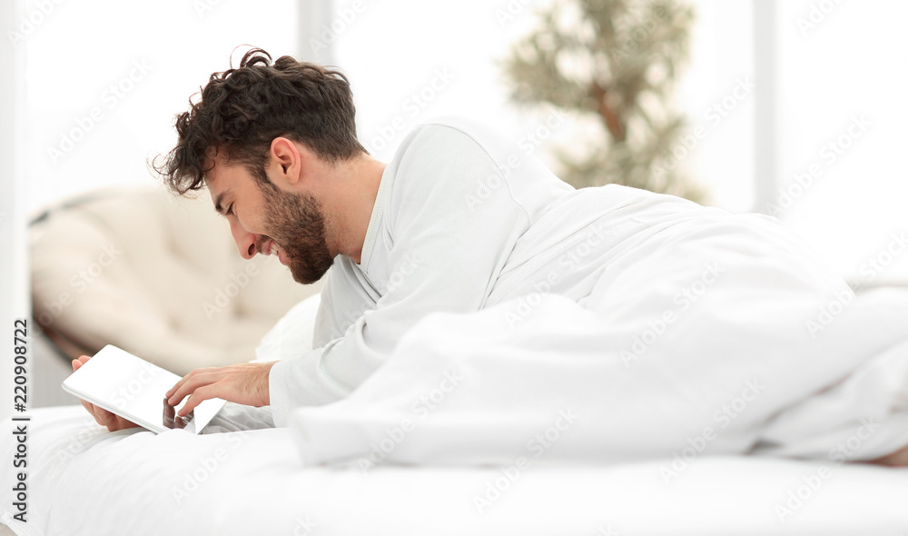 closeup.awakened man typing on a digital tablet. closeup.awakened man typing on a digital tablet.