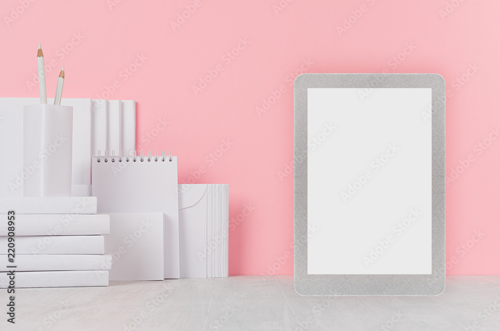 School template - white books, stationery, blank stickers and tablet computer on white desk and soft pink background. Back to school background with copy space. School template - white books, stationery, blank stickers and tablet computer on white desk and soft pink background. Back to school background with copy space.
