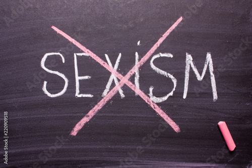 Stop sexism is written on a chalkboard