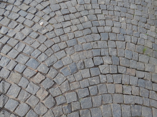 The road paved with gray cobblestone