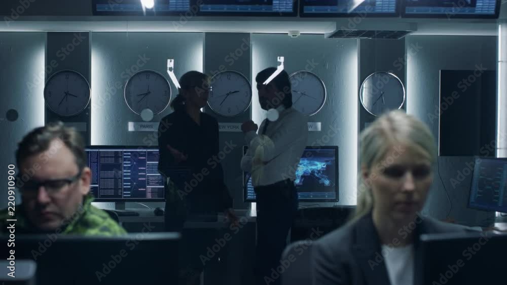 Government Cybersecurity Agency Senior Officers Have Discussion while Team of Professionals Work on Computers in Cooperation with Military. Specialists Working on Computers in System Control Room.