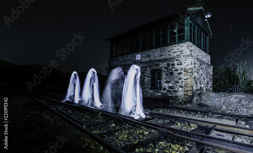 Canvas Print Four ghosts walking on the train track