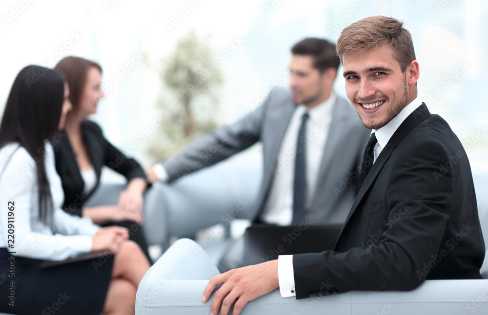 successful handsome businessman sitting at a work Desk on blurred background successful handsome businessman sitting at a work Desk on blurred background