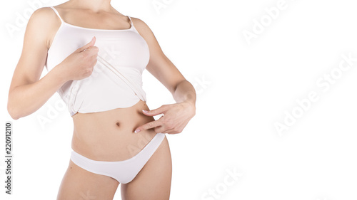Muscular woman's body in lingerie isolated on white background.