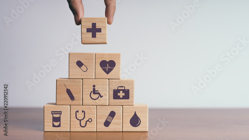 Concept of Insurance for your health, Hand hold wooden block with icon healthcare medical