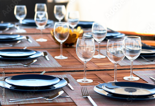 Table setting with a wine glasses, cutlery and plates