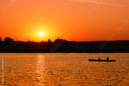 Fototapeta Naklejka Na Ścianę i Meble -  A canoeist floating on a large lake 