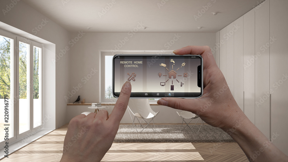 Remote home control system on a digital smart phone tablet. Device with app icons. Interior of minimalist living room in the background, architecture design Remote home control system on a digital smart phone tablet. Device with app icons. Interior of minimalist living room in the background, architecture design