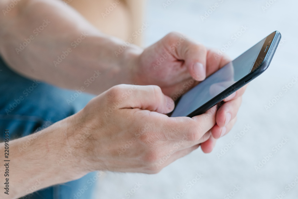 idle lifestyle and leisure. internet and social network addiction. mobile online shopping. man using phone. hands holding smartphone. idle lifestyle and leisure. internet and social network addiction. mobile online shopping. man using phone. hands holding smartphone.