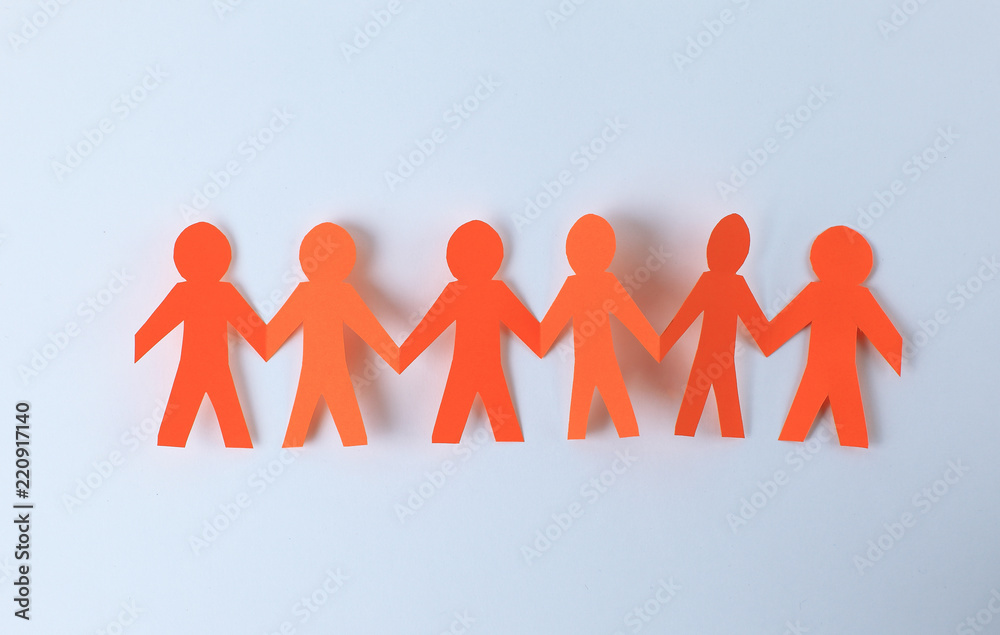 four paper men taking each other's hands four paper men taking each other's hands