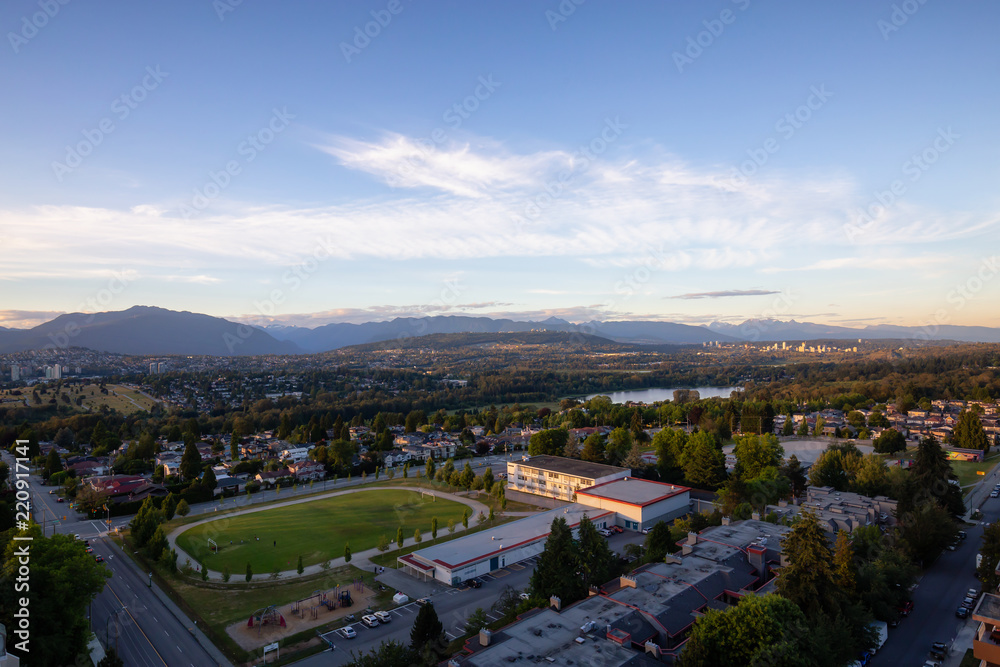 Aerial view of the modern city during a vibrant summer sunset. Taken in Burnaby, Greater Vancouver, BC, Canada.